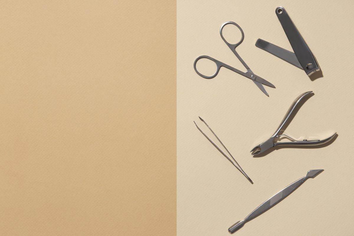 Professional manicure instruments on a beige surface